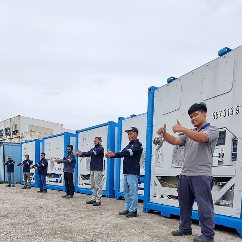 NY Container friendly staff standing in front of reefers containers with thumbs up